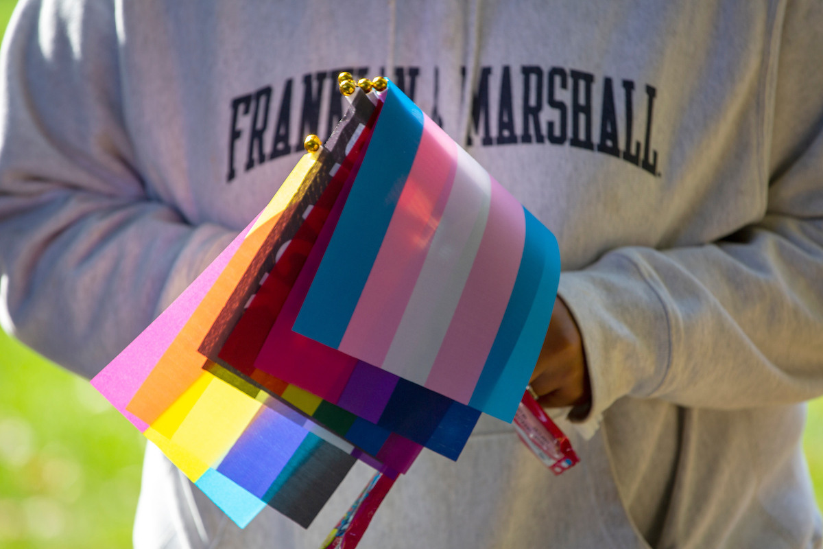 F&M student holding LGBTQ+ flags